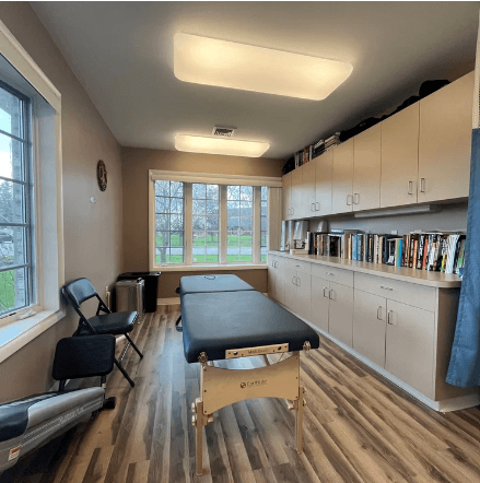 Fleming Athletics treatment room — therapy table, cabinets, and natural light