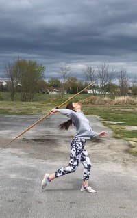 Athlete mid-throw in a javelin competition